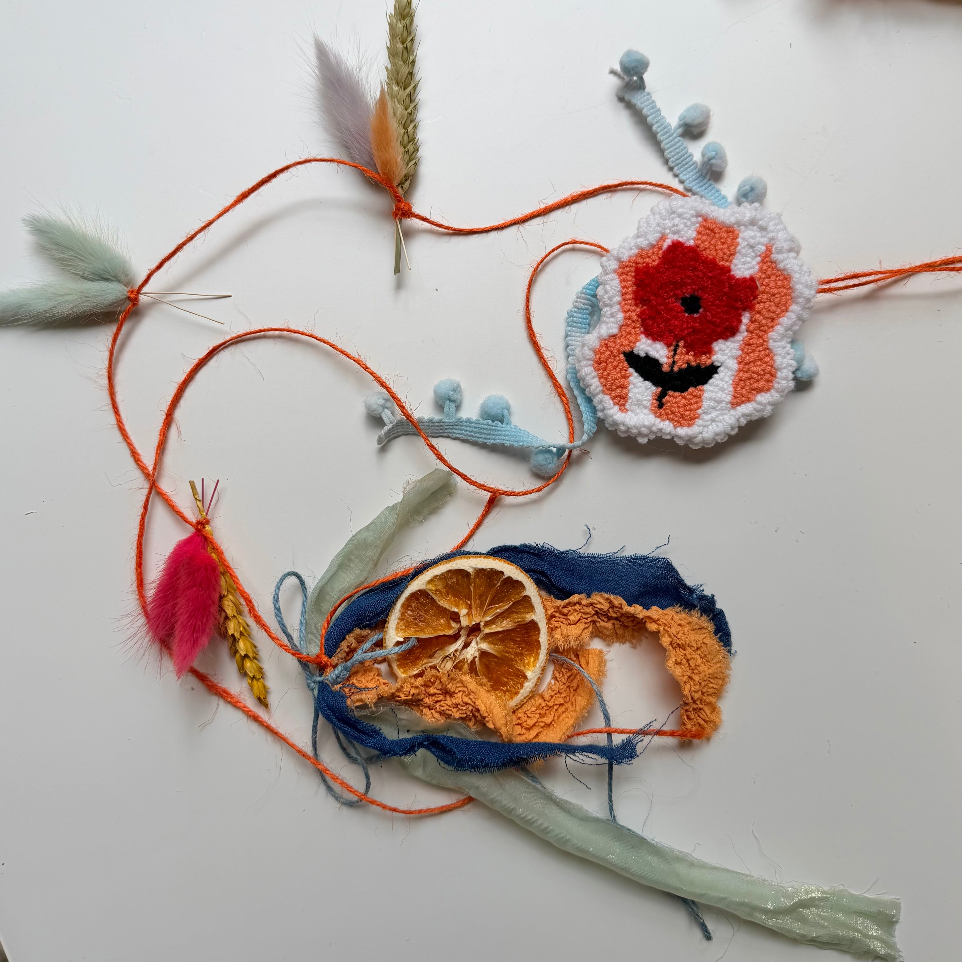 Spring garland with embroidered poppy